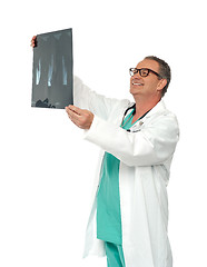 Image showing Experienced surgeon looking at x-ray report