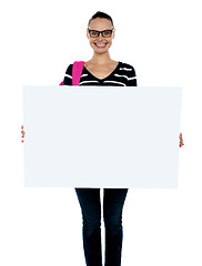 Image showing Teenager presenting white blank billboard