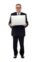 Image showing Experienced business person holding laptop