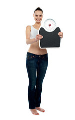 Image showing Full frame woman holding a scale