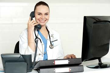 Image showing Young smiling physician sitting in clinic