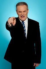 Image showing Angry senior businessman pointing finger at you