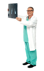 Image showing Full length shot of a surgeon with x-ray report