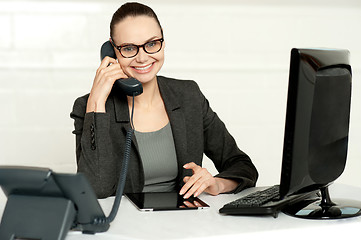 Image showing Businesswoman in glasses communicating on phone