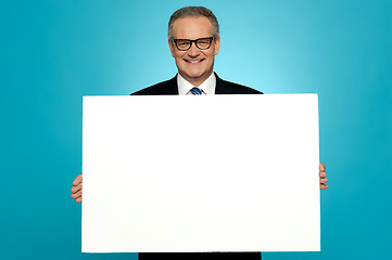 Image showing Business representative holding blank ad board