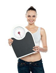 Image showing Healthy young woman with a weighing scale