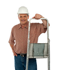 Image showing Smiling aged worker posing with ladder