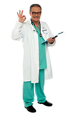 Image showing Male physician with excellent gesture holding clipboard