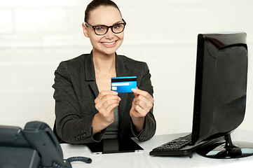 Image showing Smiling corporate lady showing credit card