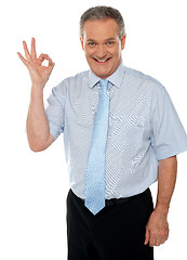 Image showing Cheerful male executive showing okay sign