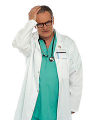 Image showing Senior physician having headache