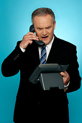 Image showing Angry aged corporate man yelling on phone