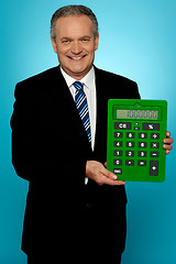 Image showing Senior manager showing big green calculator