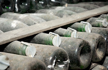 Image showing wine bottles in a cellar