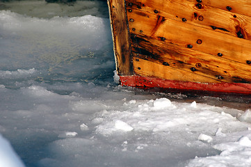 Image showing Wooden boat in ice