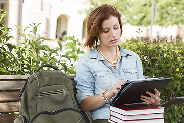 Image showing Young Female Student Outside on Bench Using Touch Tablet