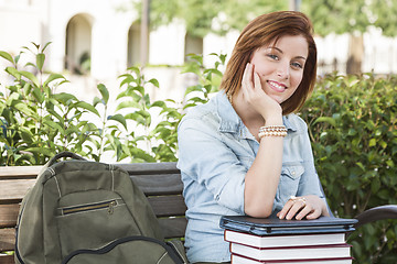 Image showing Young Female Student Sitting On Campus with Backpack and Books