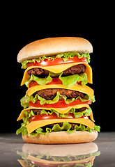 Image showing Tasty and appetizing hamburger on a dark