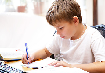 Image showing boy behind a desk