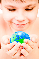 Image showing boy holds globe in hands