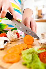 Image showing Woman's hands cutting vegetables