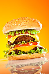 Image showing Tasty and appetizing hamburger on a yellow