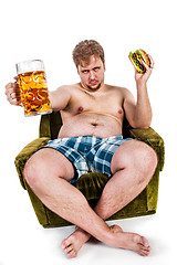 Image showing fat man eating hamburger