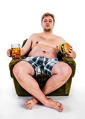 Image showing fat man eating hamburger