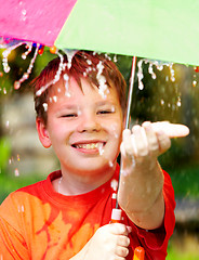 Image showing boy under an umbrella during a rain