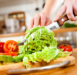 Image showing Woman's hands cutting vegetables