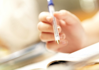 Image showing hand of the person holds pen