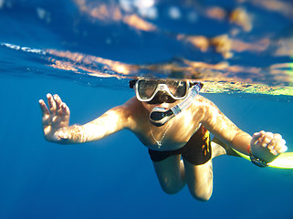 Image showing  boy floats under water