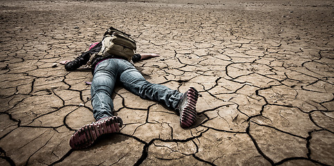 Image showing person lays on the dried ground