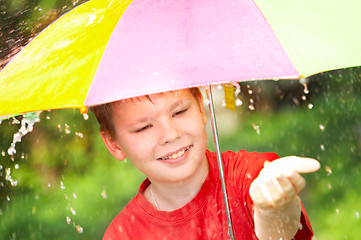 Image showing boy under an umbrella during a rain