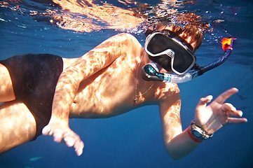 Image showing  boy floats under water