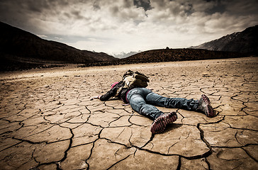 Image showing person lays on the dried ground