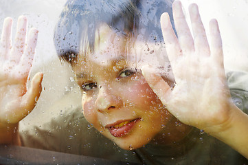 Image showing child and window on a wet rainy day