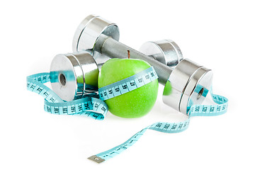 Image showing Dumbbells and apple. A healthy way of life