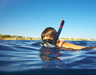 Image showing boy floats under water in the sea