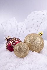 Image showing beautiful gold and red christmas decoration on white snow