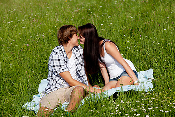 Image showing young couple outdoor in summer on blanket in love