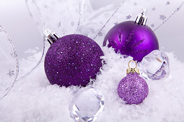 Image showing beautiful christmas decoration in purple and silver on white snow