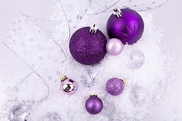 Image showing beautiful christmas decoration in purple and silver on white snow