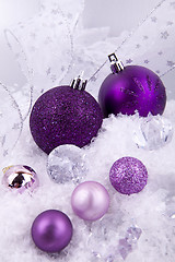 Image showing beautiful christmas decoration in purple and silver on white snow