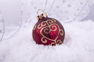 Image showing beautiful gold and red christmas decoration on white snow