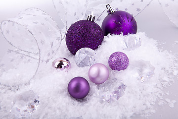 Image showing beautiful christmas decoration in purple and silver on white snow