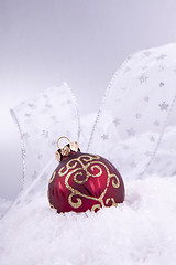 Image showing beautiful gold and red christmas decoration on white snow