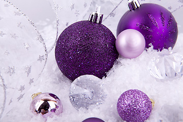 Image showing beautiful christmas decoration in purple and silver on white snow