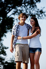 Image showing young woman and man is walking on a road in summer outdoor