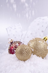 Image showing beautiful gold and red christmas decoration on white snow